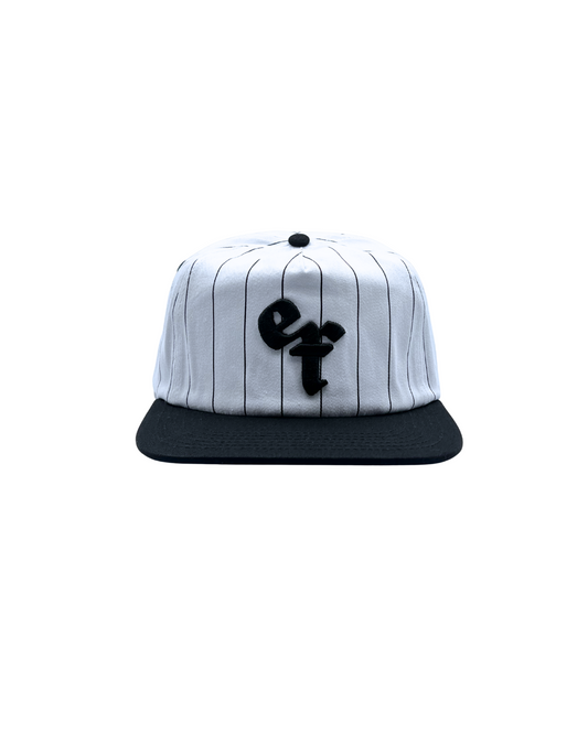 The Sports Hat represents a true staple of the 90s! This vintage athletic style classic snapback with a bold pinstripe design and unstructured silhouette is for those who put it in the work day in, day out.
Grind now, play later, and cop this 90s gem, the perfect throwback essential for streetwear lovers and active lifestyles.
90s Snapback hat with black stripe, black visor and white profile and EF logo. Vintage style snapback.