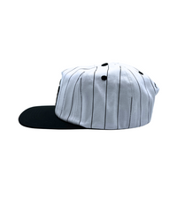 The Sports Hat represents a true staple of the 90s! This vintage athletic style classic snapback with a bold pinstripe design and unstructured silhouette is for those who put it in the work day in, day out.
Grind now, play later, and cop this 90s gem, the perfect throwback essential for streetwear lovers and active lifestyles.
90s Snapback hat with black stripe, black visor and white profile and EF logo. Vintage style snapback.