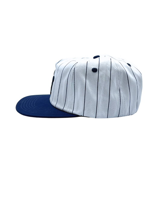 The Sports Hat represents a true staple of the 90s! This vintage athletic style classic snapback with a bold pinstripe design and unstructured silhouette is for those who put it in the work day in, day out.
Grind now, play later, and cop this 90s gem, the perfect throwback essential for streetwear lovers and active lifestyles.
90s Snapback hat with navy stripe, navy visor and white profile and EF logo. Vintage style snapback.
